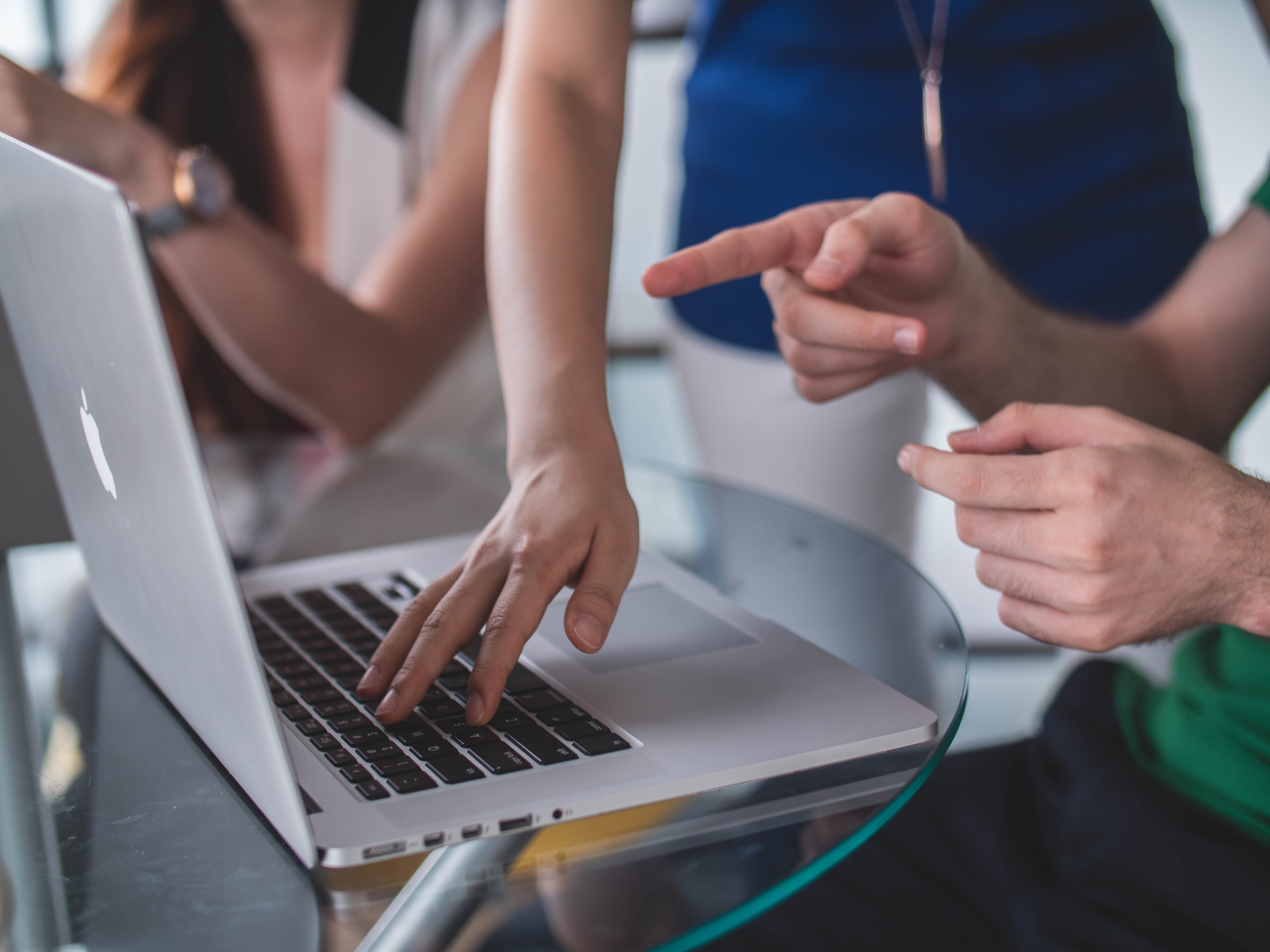 laptop with two peoples hands 