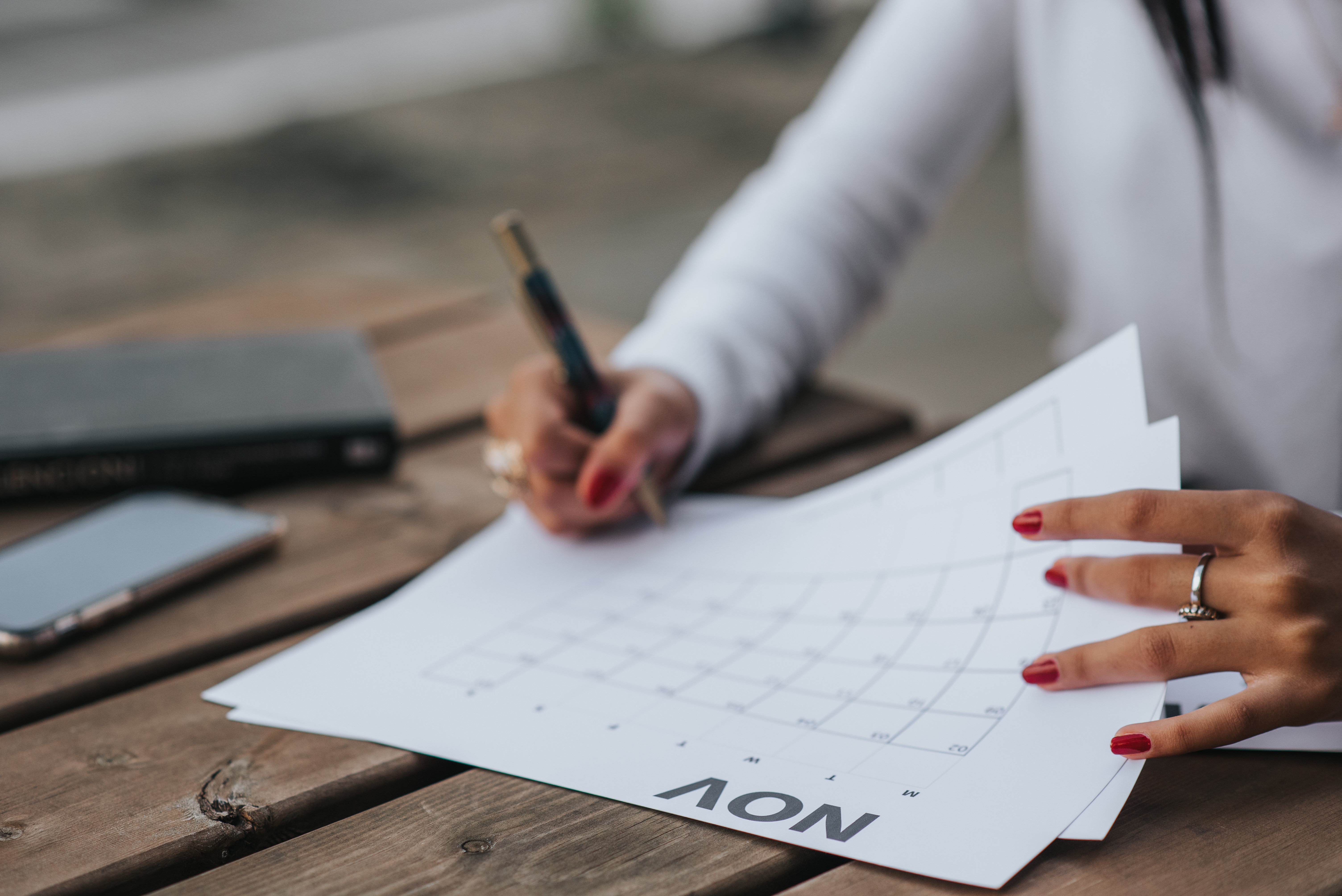 Person writing on a calendar