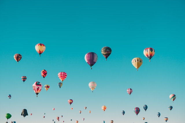 Hot air balloons going up in the sky