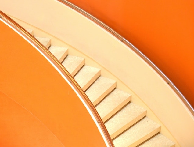 Cream stairs against orange background