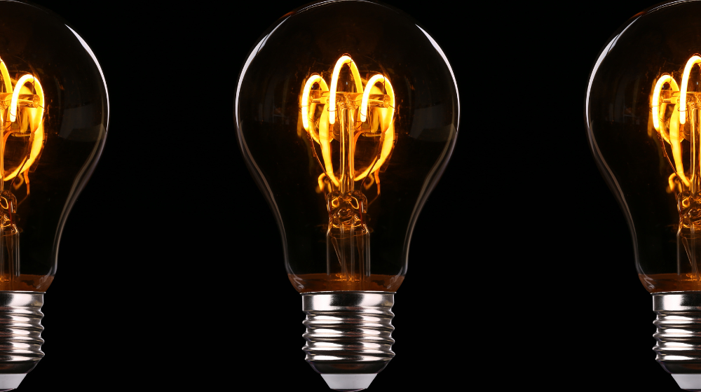Three lightbulbs on a dark background