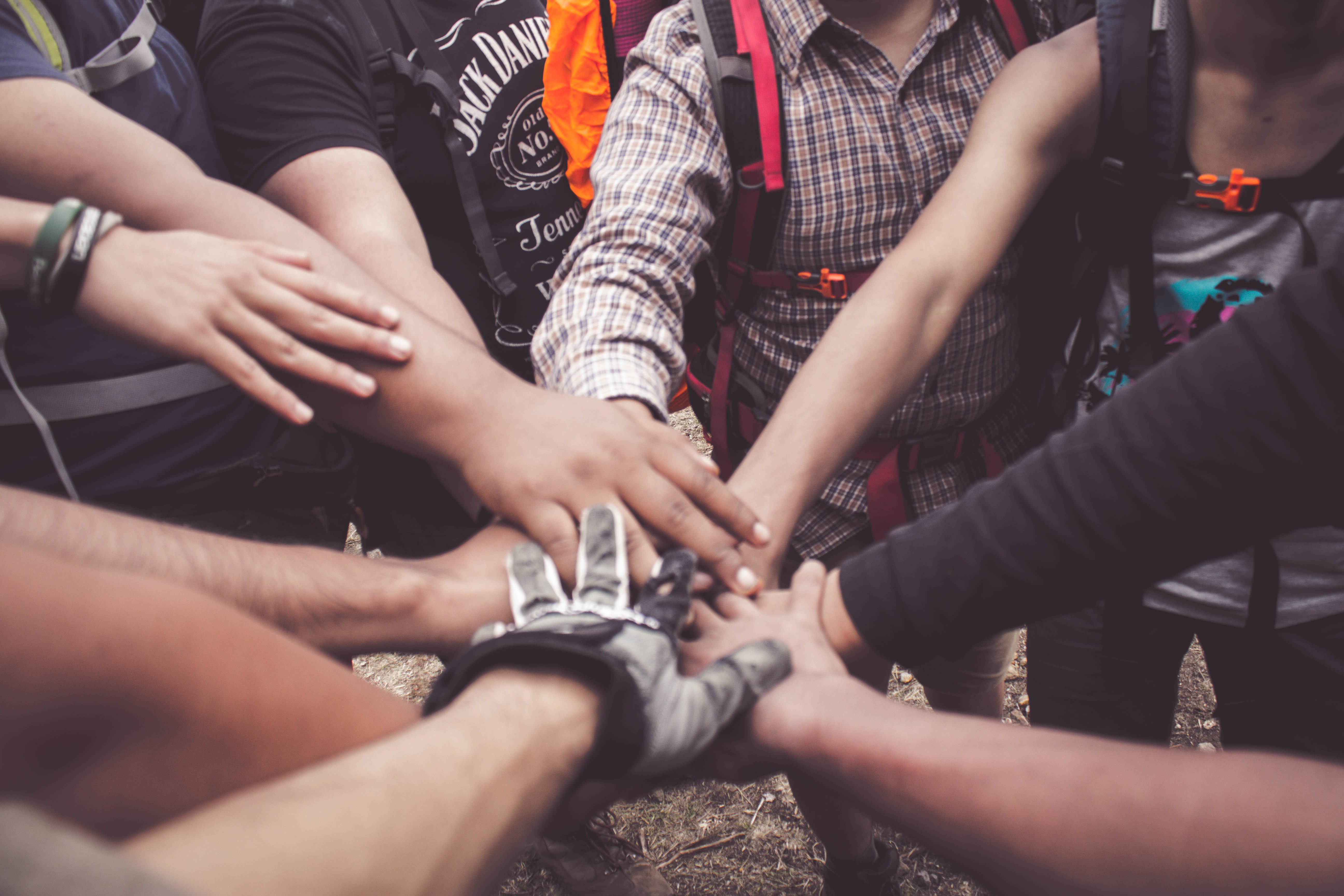 Several people joining hands