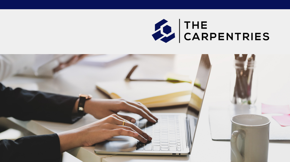 Close up of hands working on a laptop. The Carpentries logo.