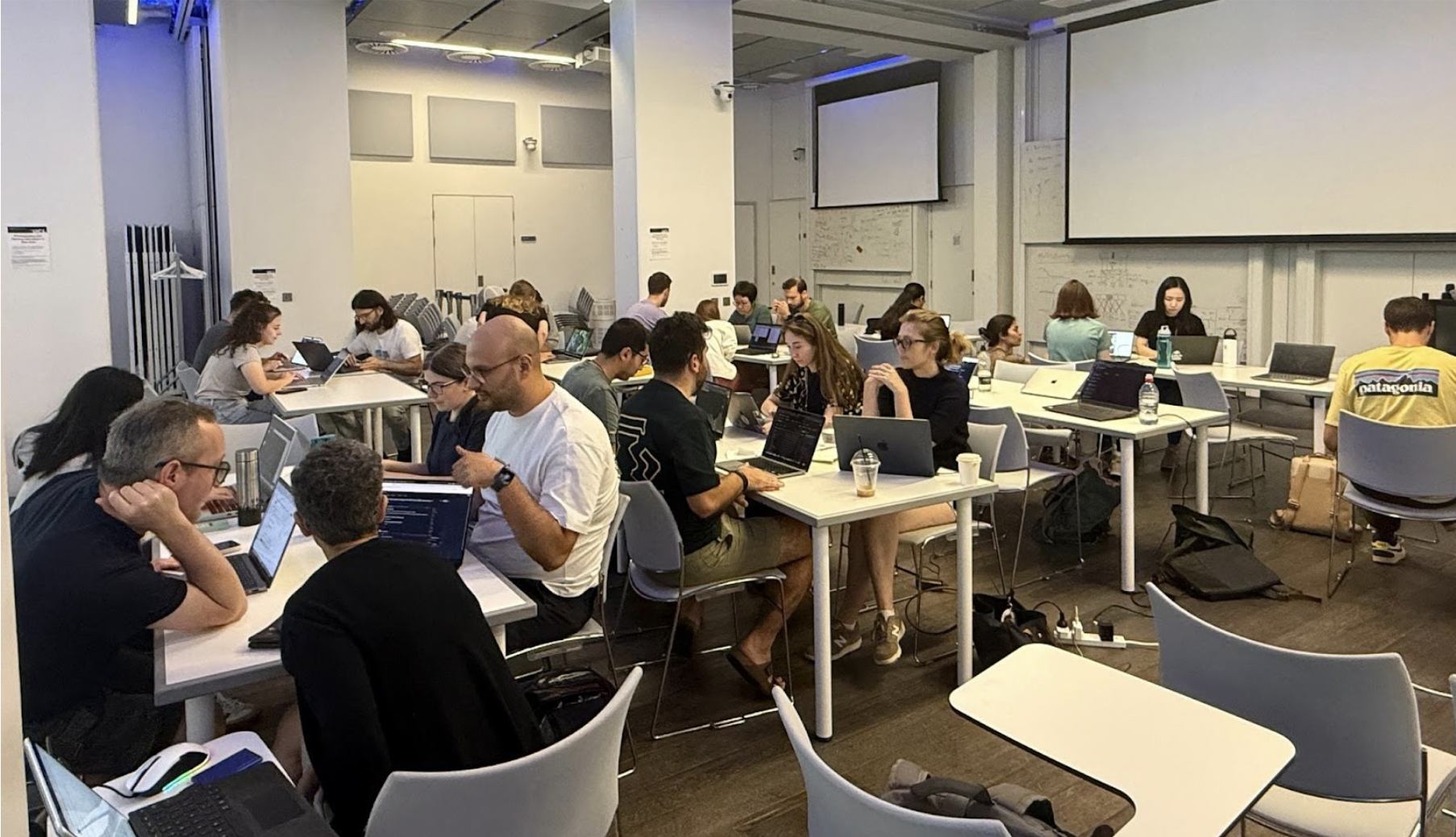 Participants of the Open Software Week looking laser-focused on their hackday projects.