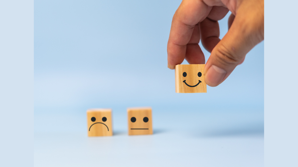 Hand picking one of three wooden blocks with reaction faces