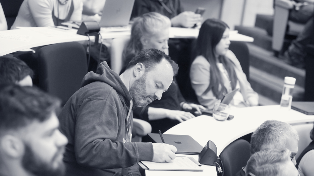 Person taking notes at CW24