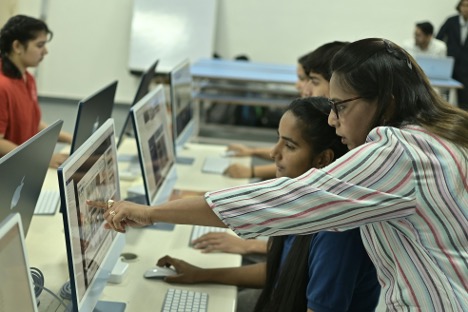 People pointing at a computer screen