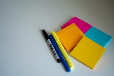 Colourful post-it notes and pens