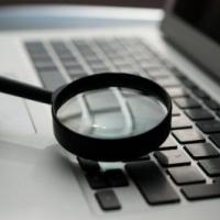 magnifying glass over laptop