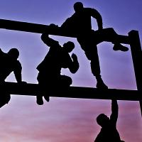 People climbing over bars